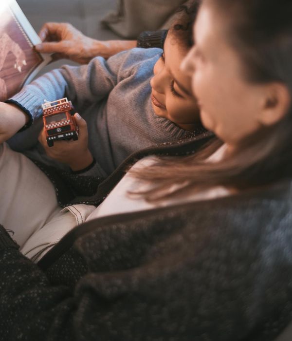 Happy child in a playful yoga pose on a colorful mat.